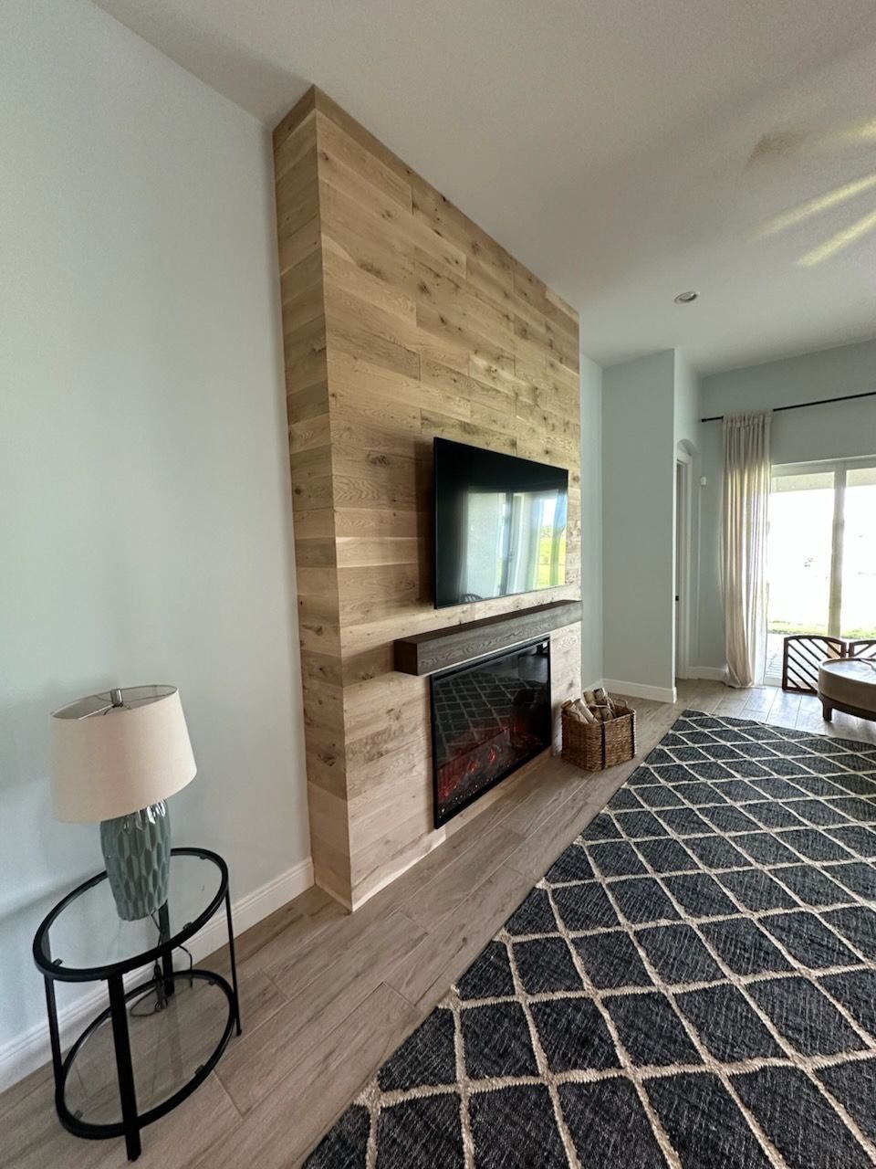 Wood plank fireplace wall with mounted TV